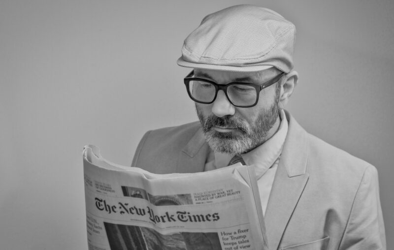man reading newspaper reading glasses